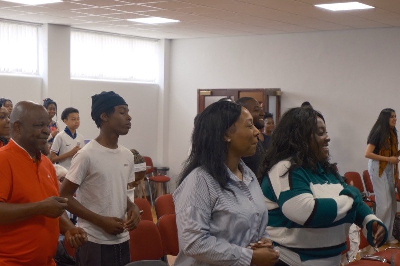 Congregation smiling and singing together