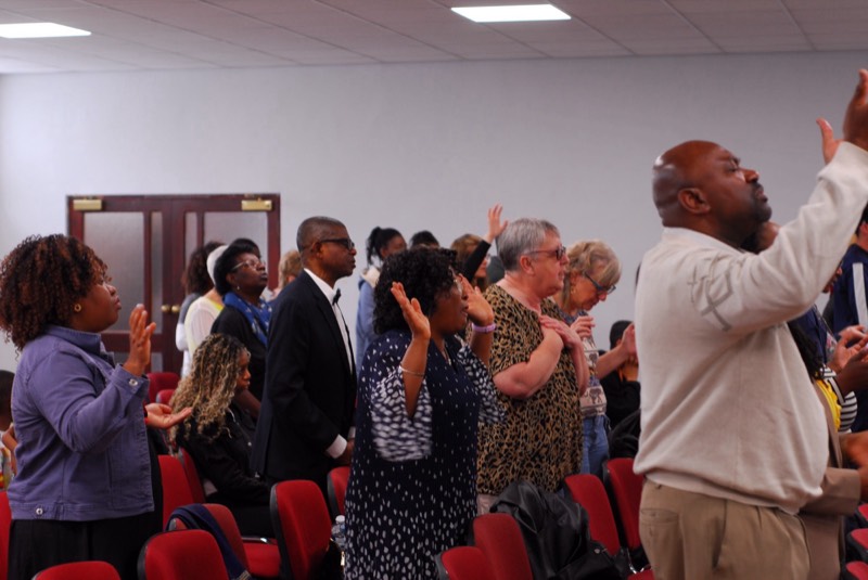 Congregation worshipping with hands raised