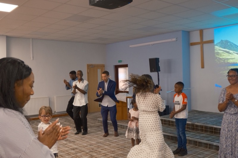 Children and adults dancing at the front